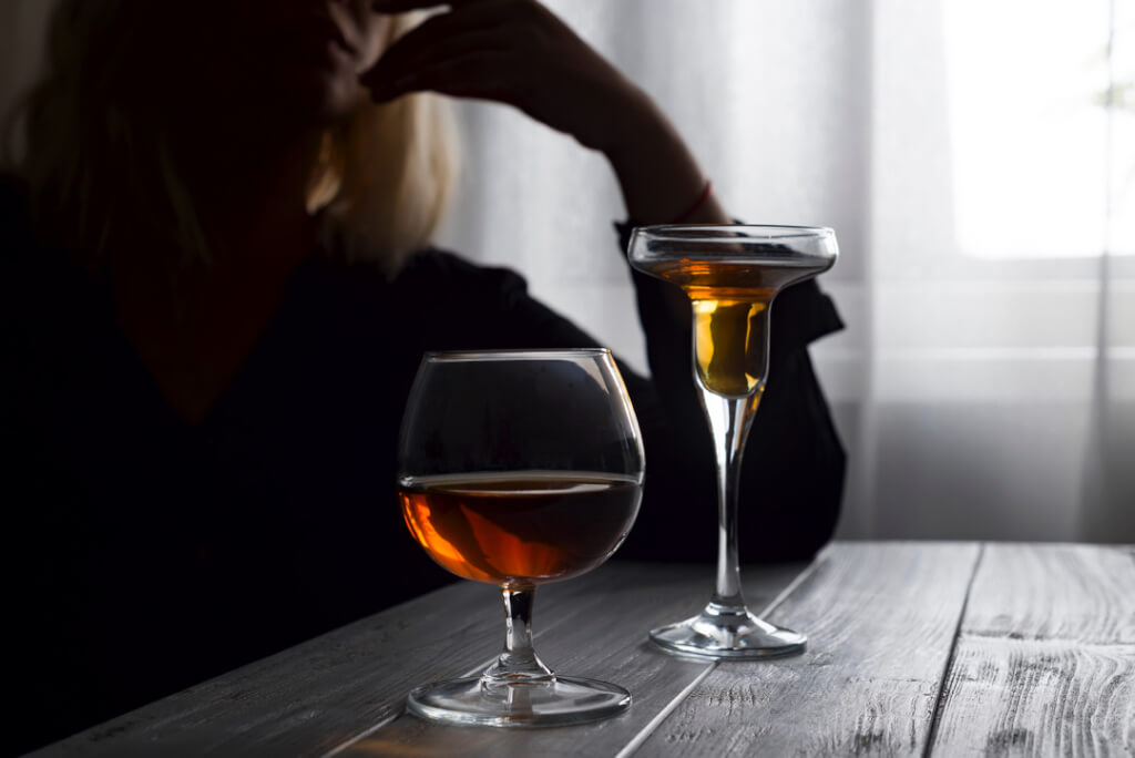 woman drinking alcohol alone