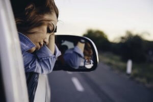 schizophrenia woman sad car road rearview