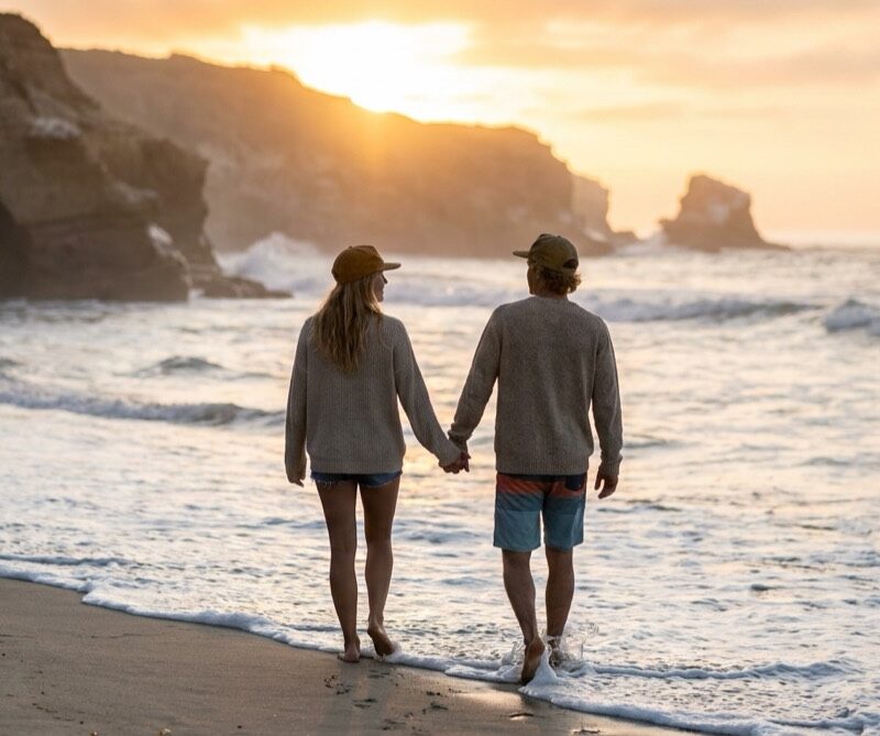 Couple beginning couples detox together, holding hands on the San Diego shoreline at sunrise