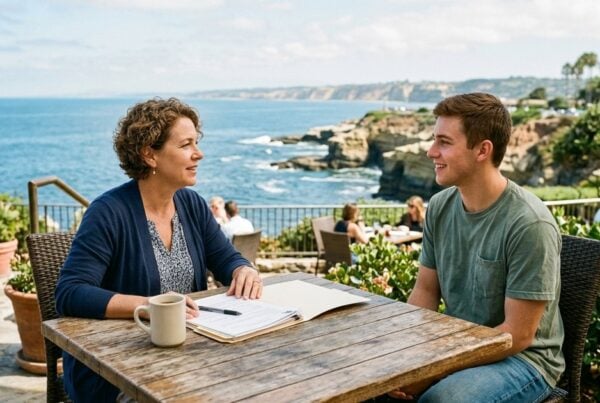 Discharge counselor talking with a young man on an ocean-view patio in La Jolla about sober living referrals